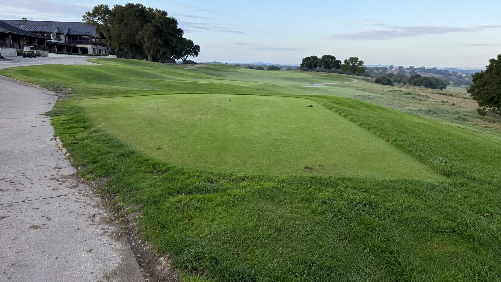 Morning view of a wide green golf lawn